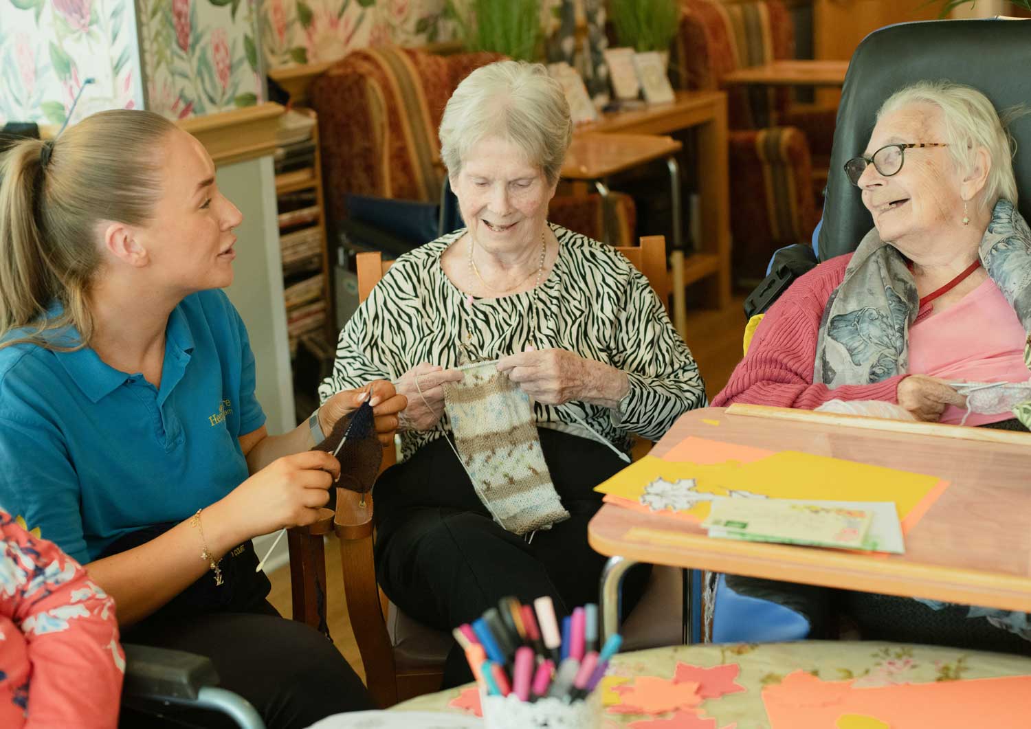 Care worker supporting service users in a warm environment